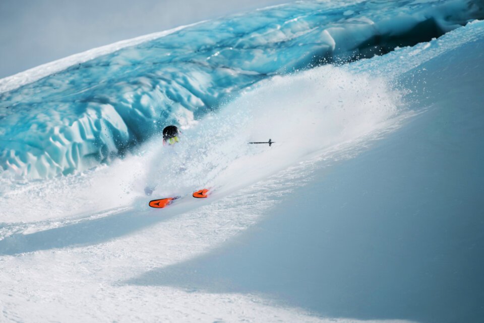 © © Christoph Johann, All Rights Reserved Skier in deep powder with a glacier in the background. | © © Christoph Johann, All Rights Reserved