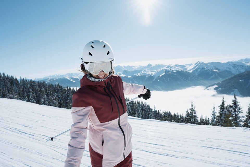 © INTERSPORT International Corporation GmbH Femme faisant du ski dans la neige avec des montagnes en arrière-plan. | © INTERSPORT International Corporation GmbH