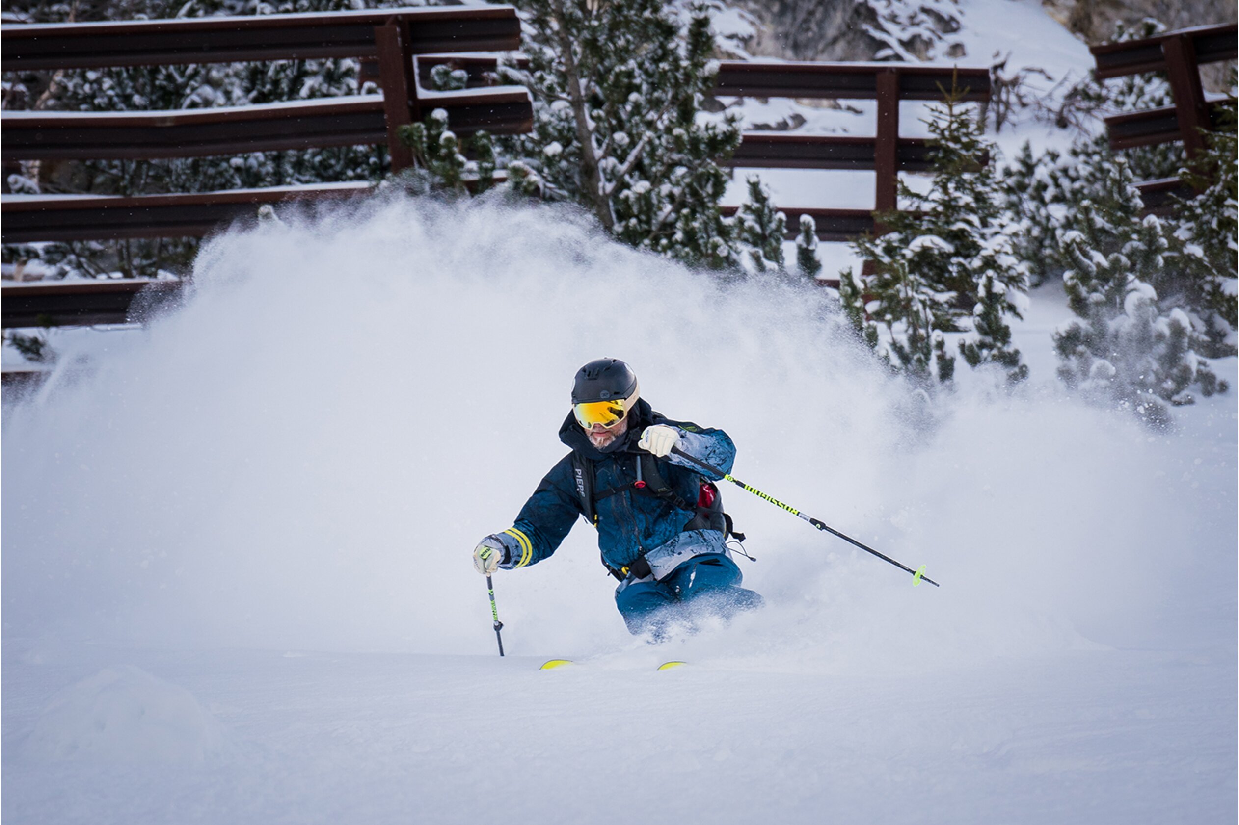 A mono-skier carving through deep powder, showcasing the suspension travel.