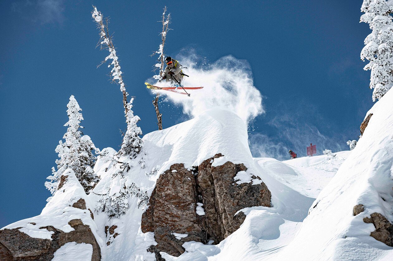 Skier jumping over a snow-covered rock formation. | © Salomon