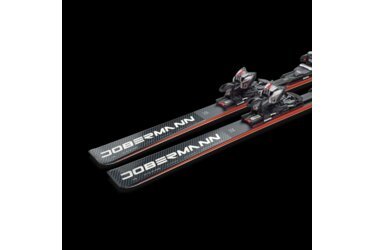 A pair of Dobermann skis with bindings on a black background.