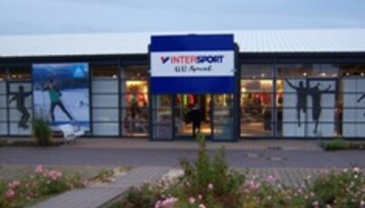 Intersport store with glass storefront and blue logo.