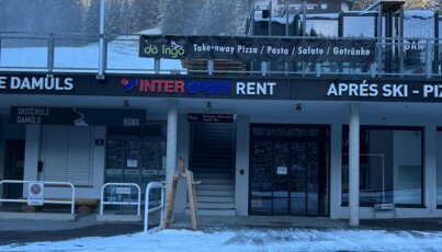 Facade of an INTERSPORT Rent shop in a snowy mountain village